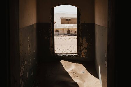 symbolic photo for decay and time passing when sand enters ruined buildingの写真素材
