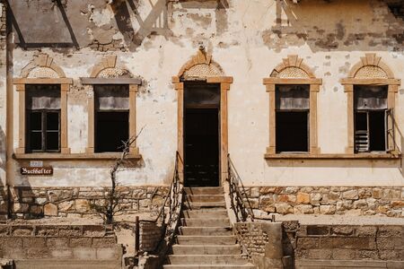 home ruins in the African desert sunk in sandの写真素材