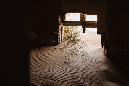 symbolic photo for decay and time passing when sand enters ruined buildingの写真素材