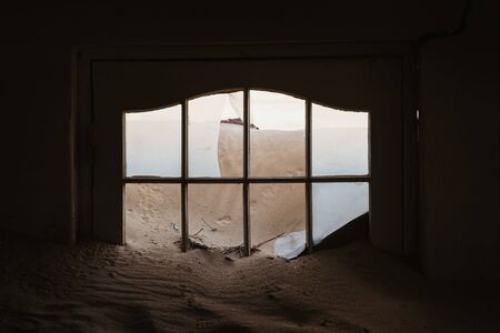 Sand has invaded and taken over these rooms in Kolmanskoppe, Namibia, Africa, plenty of copyspaceの写真素材