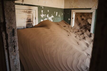 Sand has invaded and taken over these rooms in Kolmanskoppe, Namibia, Africa, plenty of copyspaceの写真素材