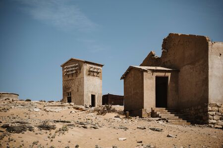 symbolic photo for decay, death and time passing when desert sand enters ruined building in Kolmanskop, Namibia, Africaの写真素材