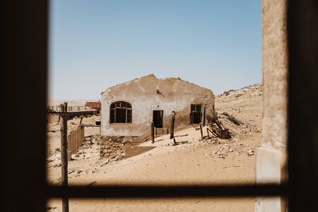 view outside and old desert builing on to other abandoned houses in the sand of Southern Africaの写真素材