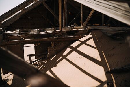 Wooden dormer under construction with wooden roof beams inside an old abandoned new houseの写真素材