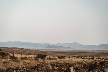 landscape image of African desert and savannah with mountain range in Northern Namibia, close to Palmwagの写真素材