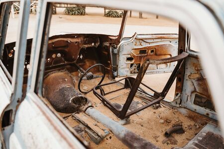 Old Timer Car Wrecks rusty and abandoned in a Desert Landscape in Solitaire, Namibiaの写真素材