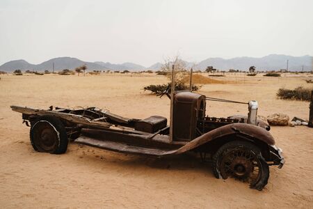Old Timer Car Wrecks rusty and abandoned in a Desert Landscape in Solitaire, Namibiaの写真素材