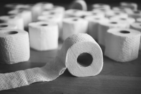 Stack of white tissue toilet paper rolls, black and white photoの写真素材