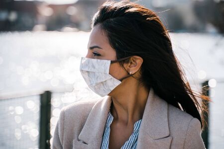 woman wearing selfmade protection mask outside in sunの写真素材
