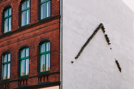 bricks on a housewall in shape of a regular roof