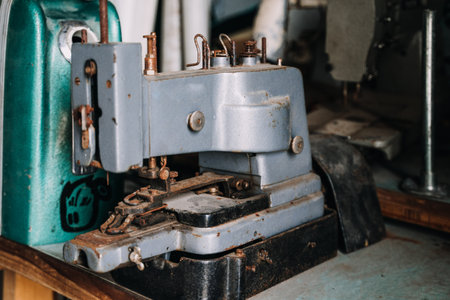 Closeup photo of old sewing machine and item of clothing, vintage retro styleの写真素材
