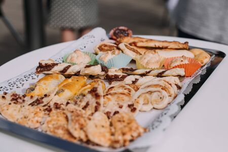 Salty and cheese bar of several kinds of cheese, grapes, olives and snacks decorated on vintage wooden table. Wedding or other holiday party outdoorsの写真素材