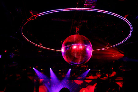 sparkling disco ball. Night party in red purple lights