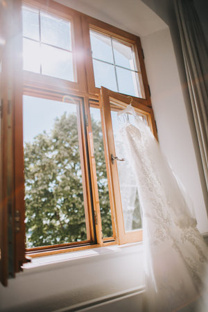 beautiful wedding dress hanging in the room, bridal accessories, wedding European, American Wedding. Vertical portrait photoの写真素材