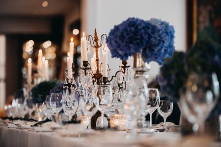 photo of dinner table with empty plates on and flowersの写真素材