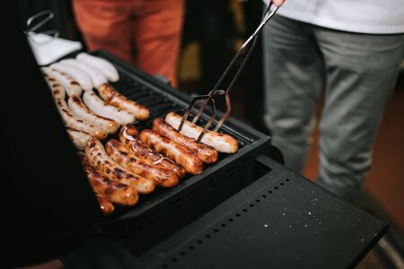 photo of hotdog and bread grilling outdoor in partyの写真素材