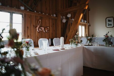 photo of an empty wedding hall with many tablesの写真素材