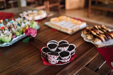 photo of chocolate cupcake in a plate on a wooden tableの写真素材