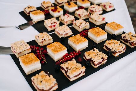 photo of pieces of different cakes in a plateの写真素材