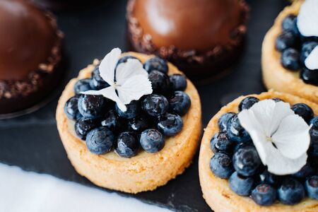 photo of many delicious blueberry small tartsの写真素材