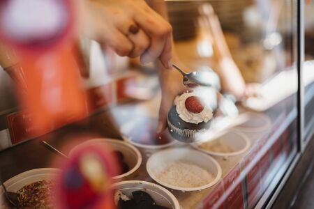 photo of cup cake serving in a storeの写真素材