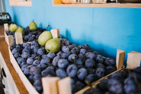 photo of plums in a basket with pearsの写真素材