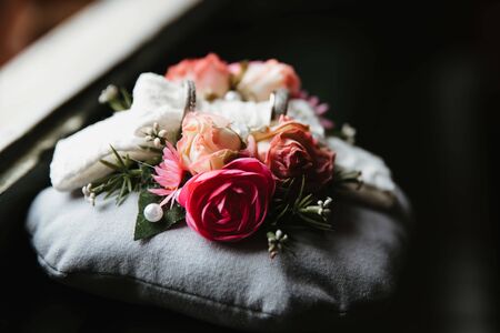 photo of two wedding rings on a pillowの写真素材