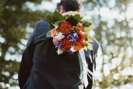 a groom and a bride holding a bouquetの写真素材