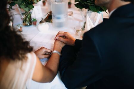 a couple holding hands at a dinnerの写真素材