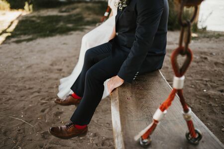 a bride an a groom on a swingの写真素材