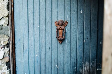 an old house blue door with hand bellの写真素材