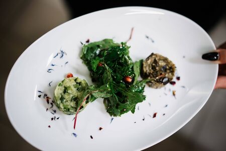 a woman holding a spinach salad dishの写真素材