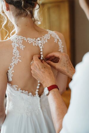 a bride getting ready wearing a dressの写真素材