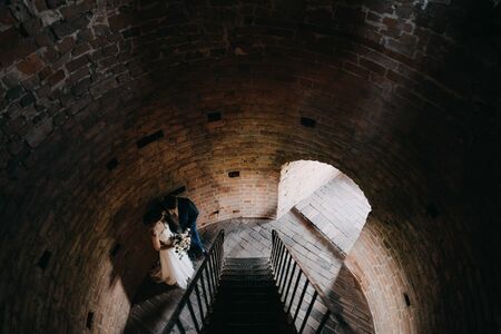 a married couple standing on stairsの写真素材