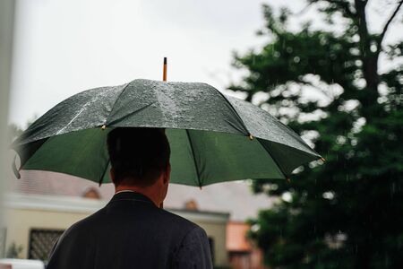a man holding an umbrellaの写真素材
