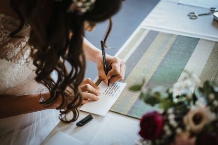 a bride writing a cardの写真素材
