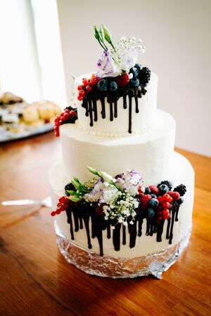 white wedding cake with berriesの写真素材