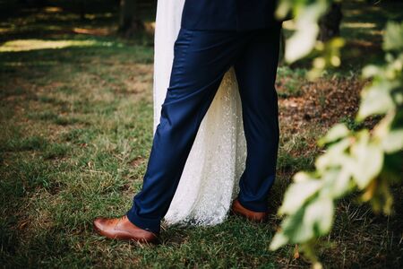 wedded couple standing in a green gardenの写真素材