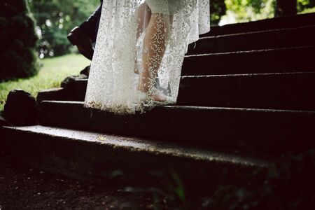 a bride and a groom going up on stairsの写真素材