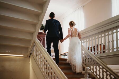 a bride and a groom going upstairsの写真素材
