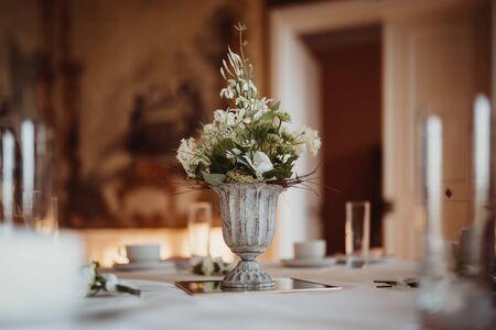 a flower vase on a table with candlesの写真素材