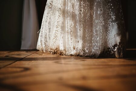 a brides dress on a wooden floorの写真素材