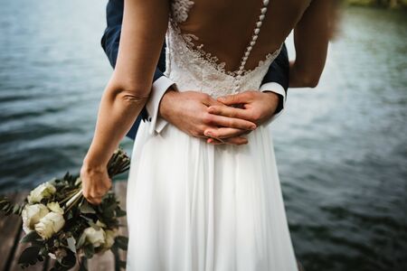 a wedded couple at a lakeの写真素材