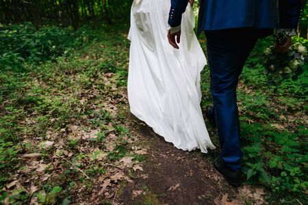a wedded couple walking in a forestの写真素材