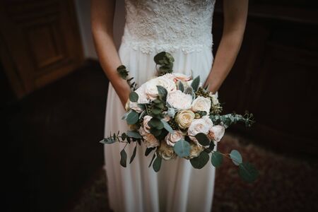 a bride holding a bouquet of flowersの写真素材