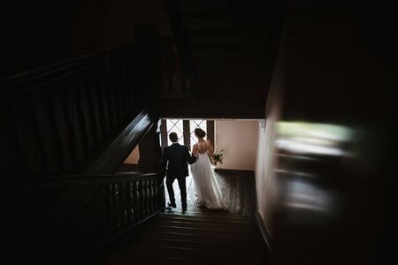 a bride and a groom going downstairsの写真素材