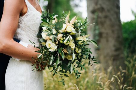 a wedded couple standing in a forestの写真素材