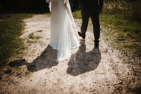 a wedded couple walking in a parkの写真素材