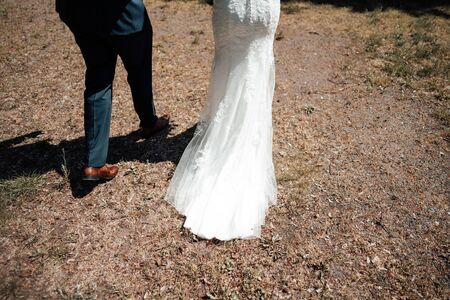 a wedded couple walking in a parkの写真素材