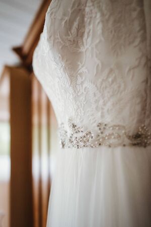 a wedding dress hanged on a closetの写真素材